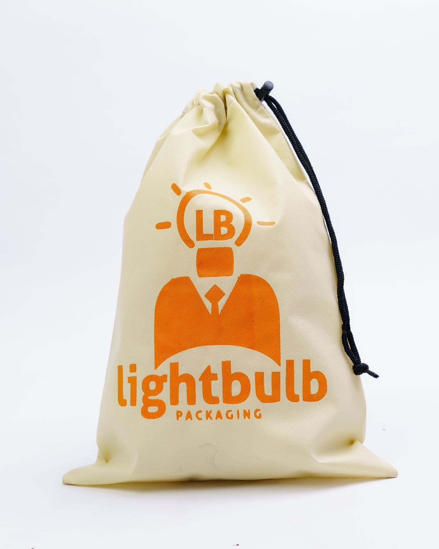 Cream drawstring bag with orange print