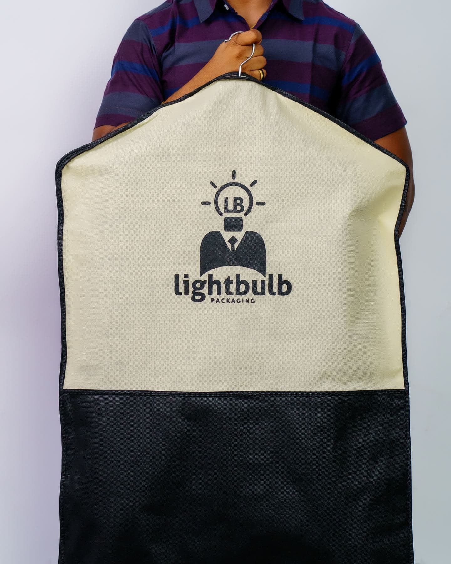 Cream and black branded garment bag by Lightbulb Packaging